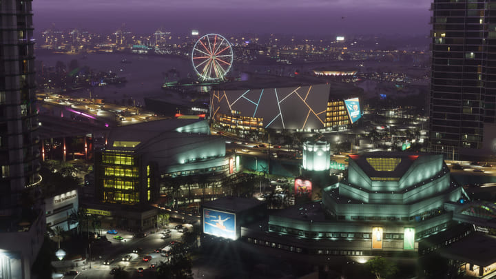 Vice City bij nacht van bovenaf, met reuzenrad en lichtreclames